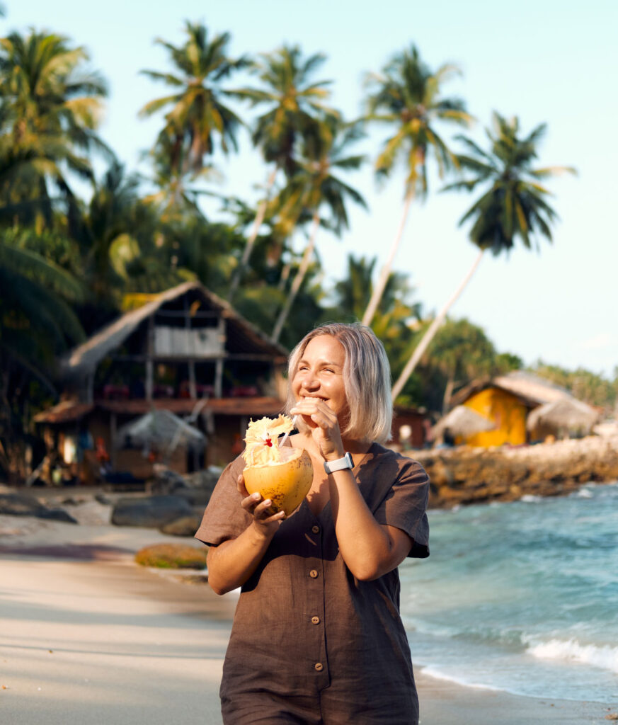 woman drink coconut juice on the beach